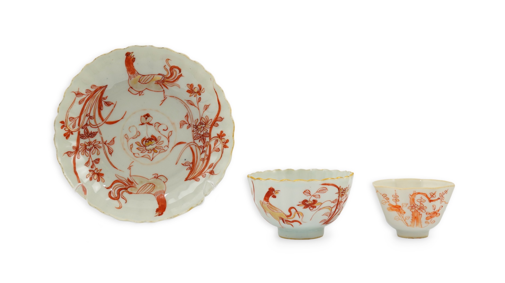 A Chinese rouge de fer tea bowl and saucer and a similar cup, Qianlong period